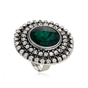 Vintage silver adjustable ring featuring a large green crystal with double diamond halos