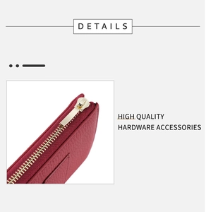 Detail showing high-quality gold hardware and zipper on wine red pebbled leather wallet