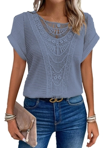 Detailed close-up of blue short-sleeved top featuring intricate lace stitching and eyelet knit