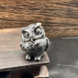 Detail of 3.5cm natural stone owl statue with realistic carved grey and black granite texture