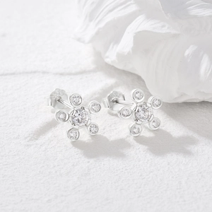 Detailed macro shot of S925 sterling silver flower earrings with sparkling cubic zirconia
