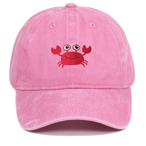 Close-up of a cartoon crab embroidery on a pink washed cotton baseball cap