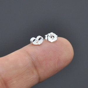 S925 sterling silver butterfly earring backs shown on fingertip for size reference