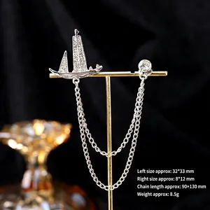 Detailed view of rhinestone sailboat suit brooch with elegant double layer chains
