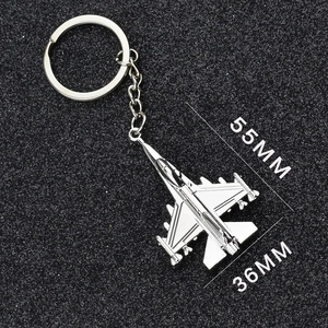 Detail view of silver metal fighter jet keychain with 55mm length and 36mm wingspan