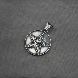 Vintage stainless steel pentagram necklace with central goat head design on gray fabric