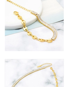 Close-up of golden anchor chain necklace with square zircon and lobster clasp