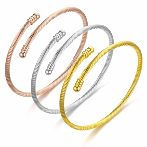 Group of stylish titanium steel cable wire cuff bracelets in rose gold, silver, and gold finish