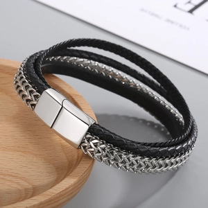 Close-up of multilayer braided leather bracelet with silver chain and magnetic buckle