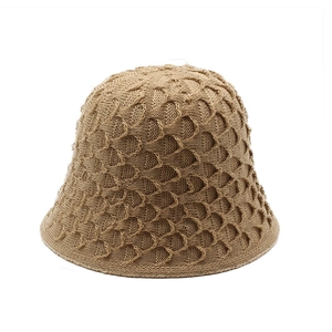 Macro shot of khaki crochet knit bucket hat featuring textured scale-pattern weaving