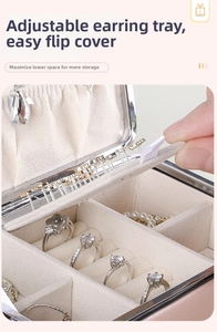 Detail of pink PU leather jewelry box featuring movable earring plate and ring slots