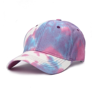 Detail view of colorful tie-dye baseball cap featuring purple and blue cotton canvas textures