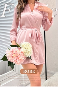 Detailed view of pink satin robe with silk texture and elegant tie-waist design