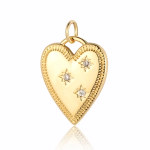 Detailed view of heart-shaped copper zircon pendant with starry gemstones and golden texture