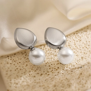 Minimalist 18K gold plated teardrop earrings with white pearls on elegant silk background