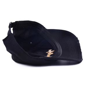 Detailed internal embroidery and distressed brim of the black Mama baseball cap