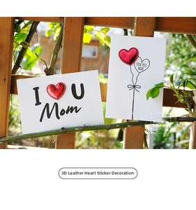 Close-up of a 3D red leather heart patch on a Mother's Day card with garden background