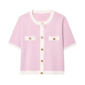 Detailed view of pink knit cardigan featuring gold embossed buttons and white contrast trim