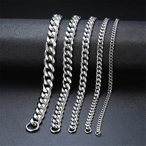 Detail view of five various thickness levels of silver Cuban link chains for men