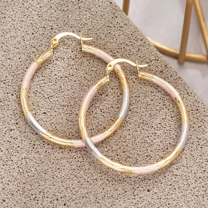 Three-tone wavy textured metal hoop earrings in gold, rose gold and silver colors