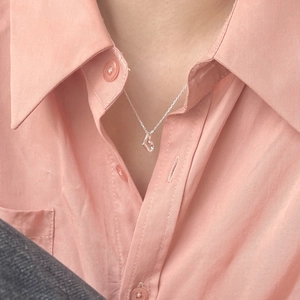 Elegant 925 sterling silver heart necklace worn with an orange collared shirt