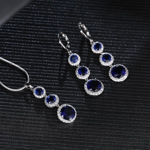 Teardrop jewelry set with dark blue zircon necklace and long earrings on black background