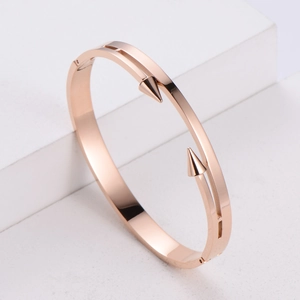 Polished rose gold stainless steel open bangle with double spearhead studs
