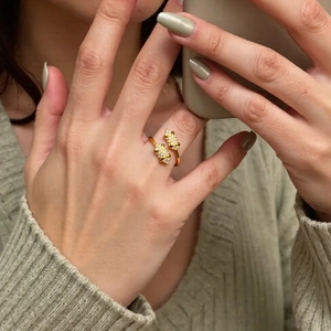 Close-up of 18K gold plated ring featuring micro-pave zircons on a model's finger