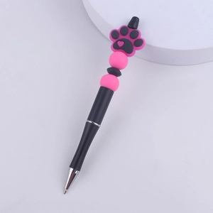 Detail of DIY beaded pen featuring pink and black silicone cat paw topper and round beads