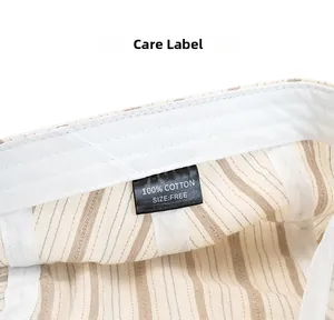 Detailed view of the 100% cotton care label and internal stitching on the striped cap