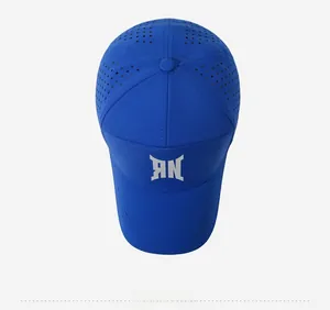 Detail of royal blue baseball cap featuring laser-cut ventilation holes and white logo