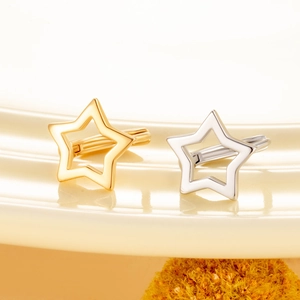 Minimalist hollow star earrings in gold and silver finish with metallic luster