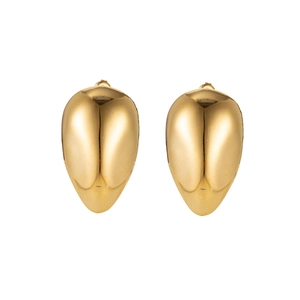Macro detail of large gold teardrop earrings with a smooth polished metallic finish