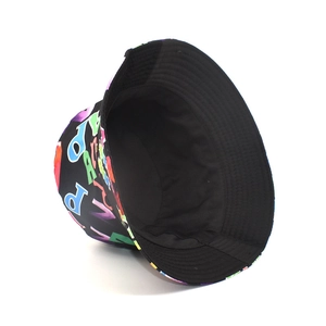 Detail of black reversible bucket hat with colorful graffiti letter print for sun protection