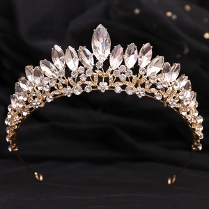 Macro shot of large clear crystals and water drop rhinestones on a golden crown