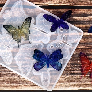 Moule en silicone papillon pour résine époxy avec exemples de créations colorées DIY