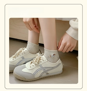Close-up of cotton crew socks with puppy embroidery and dots worn with retro sneakers