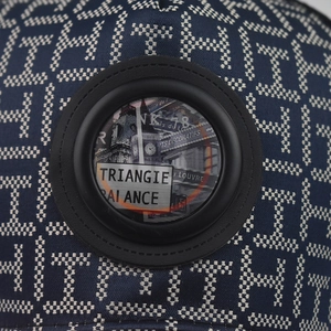 Close-up of jacquard fabric texture and leather patch detail on outdoor baseball cap