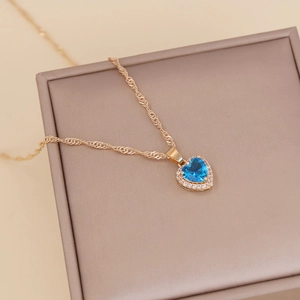 Golden heart necklace featuring a blue zircon pendant on a vintage twisted chain