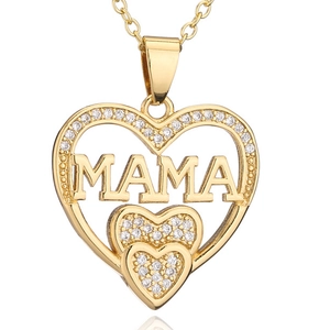 Close-up of gold heart pendant necklace with MAMA lettering and white crystals