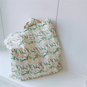 Detail der Tulpen-Stofftasche mit gekräuselter Baumwolltextur und weißem Webetikett