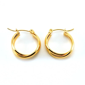 Detail shot of golden twisted double-hoop earrings in titanium steel with a polished finish
