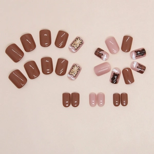 Glossy brown and pink press-on nails with cute cartoon bear designs and cloud patterns