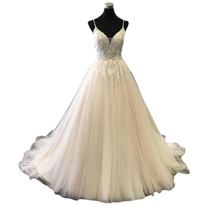 Elegant champagne A-line wedding dress with spaghetti straps and sequined lace bodice