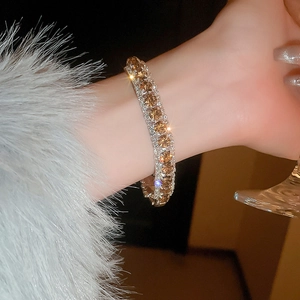 Detail of luxury geometric buckle bracelet with champagne gems and silver plating