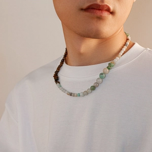Detail of men beaded necklace with natural tiger eye and jade stones on male model