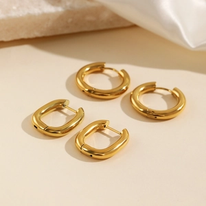 Fashion gold stainless steel geometric hoop earring set on white silk background