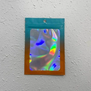 Macro detail of laser holographic resealable pouch with colorful gradient edges and hang hole