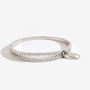 Macro view of silver zipper bangle with micro-pave cubic zirconia and pendant detail