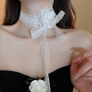 Detail of white lace flower choker featuring a large rose and elegant long ribbon